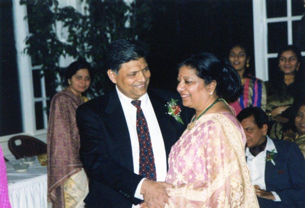 Manjula dancing with her husband at a formal event, both smiling warmly