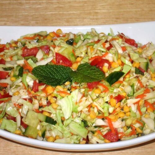 A bowl of Cabbage Chana Dal Salad garnished with fresh coriander