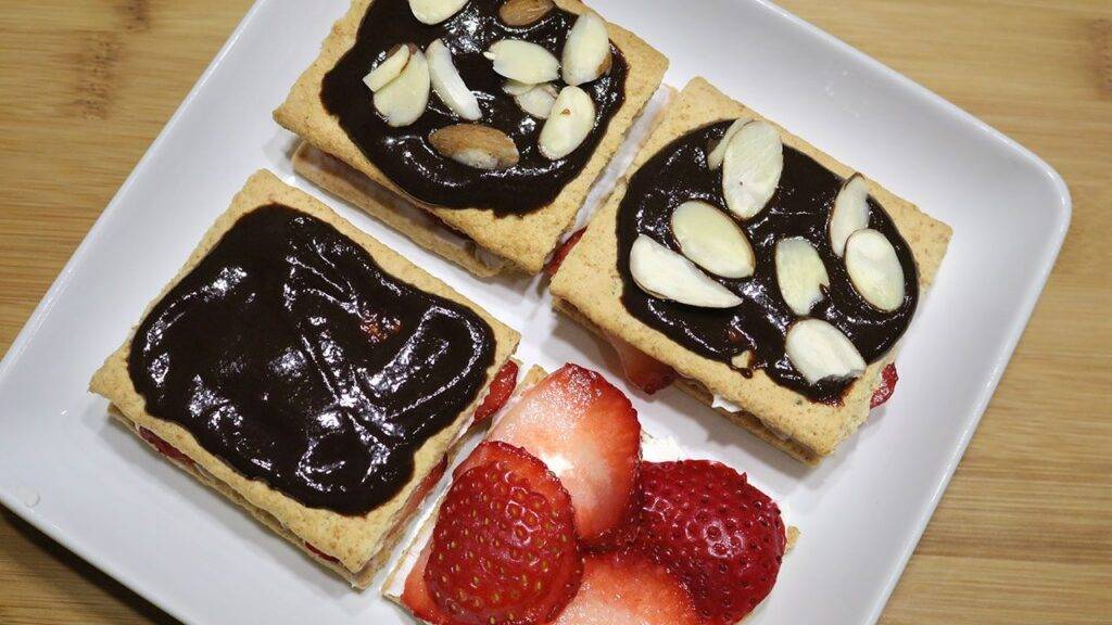 Fruit and Cracker Dessert topped with chocolate sauce and almond slices