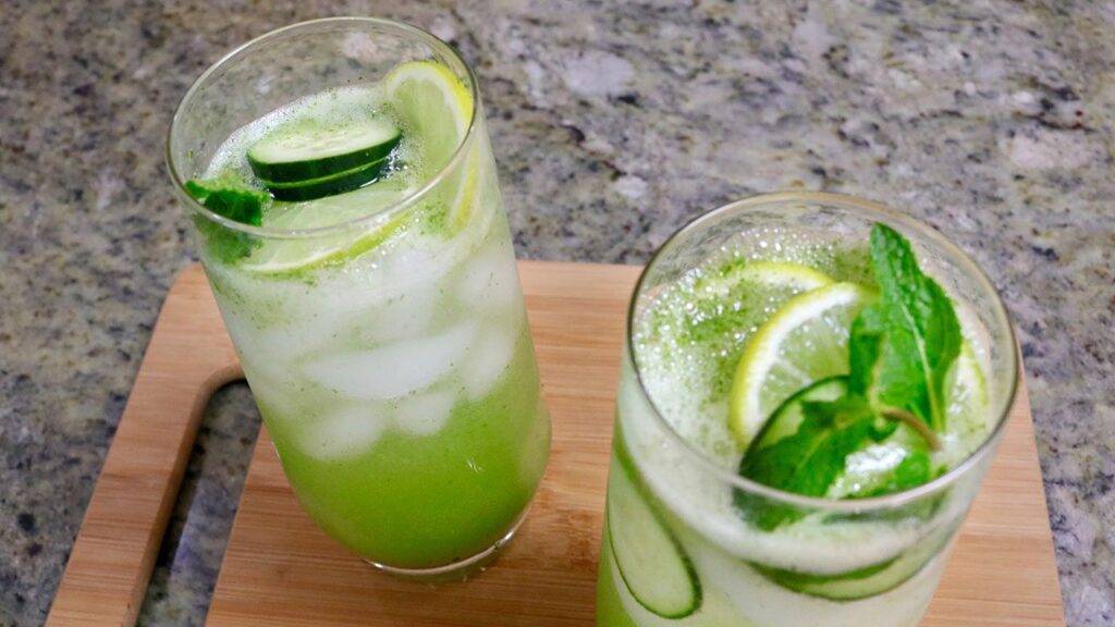 Refreshing Mojito Mocktail served in tall glasses with cucumber slices, lemon, and mint leaves.