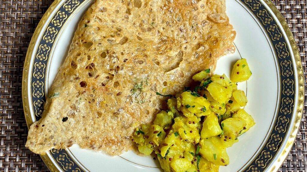 A plate of crispy Sorghum Dosa served with spiced potato filling