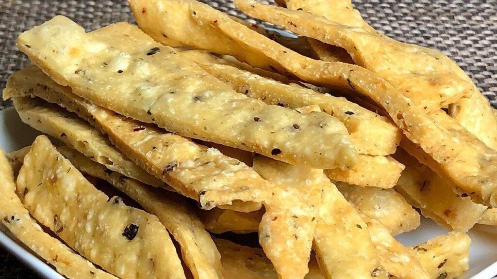 A plate of crispy Namak Para (savory fried snacks)
